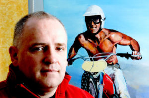 Photo: Rob Kinsey with one of his motocross paintings.
