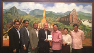 David presenting a copy of his book when discussing the creative industries in Laos (Lao PDR)